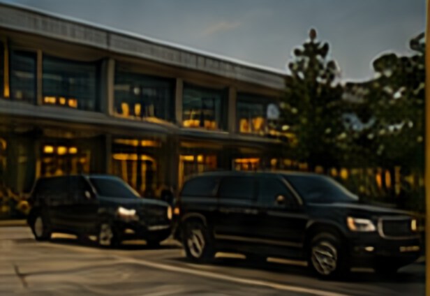 SUVs waiting at an airport terminal